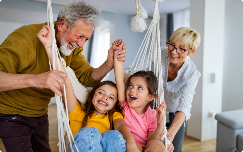 Grandparents playing with grandchildren indoors